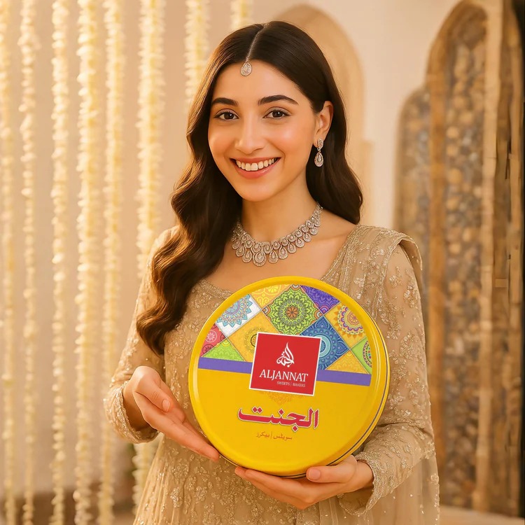 Woman holding Aljannat sweets tin